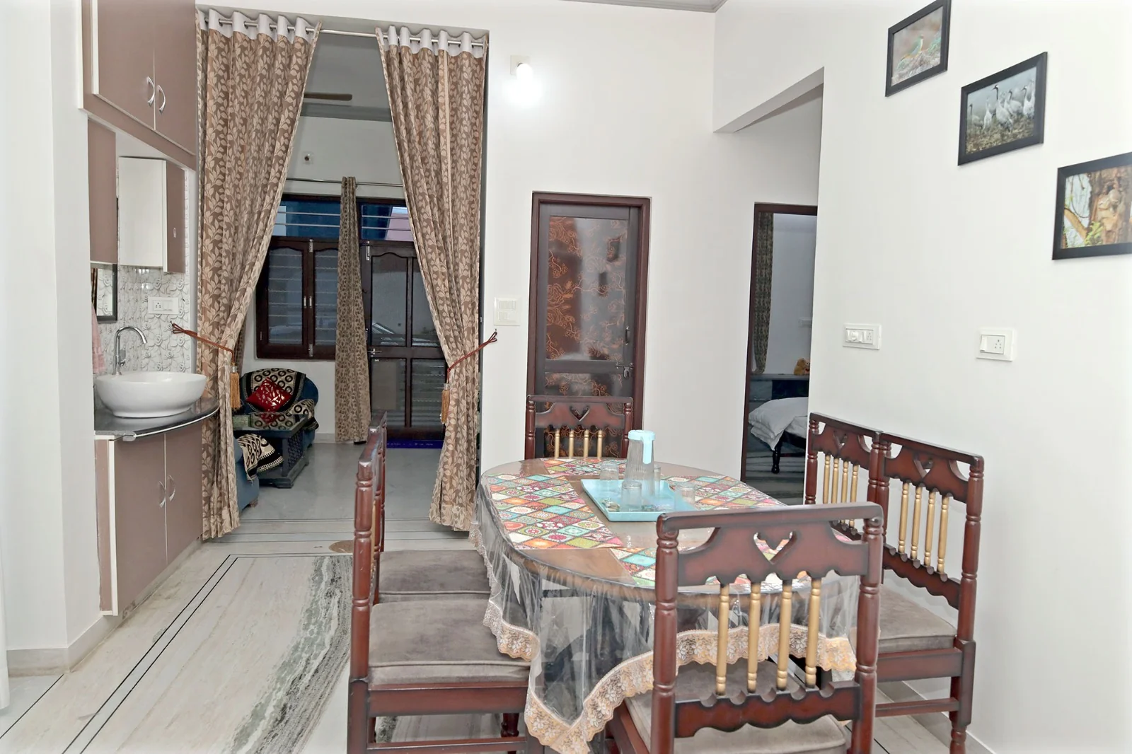 Second view of dining area with wall art at Meeraavi Home Stay, Udaipur