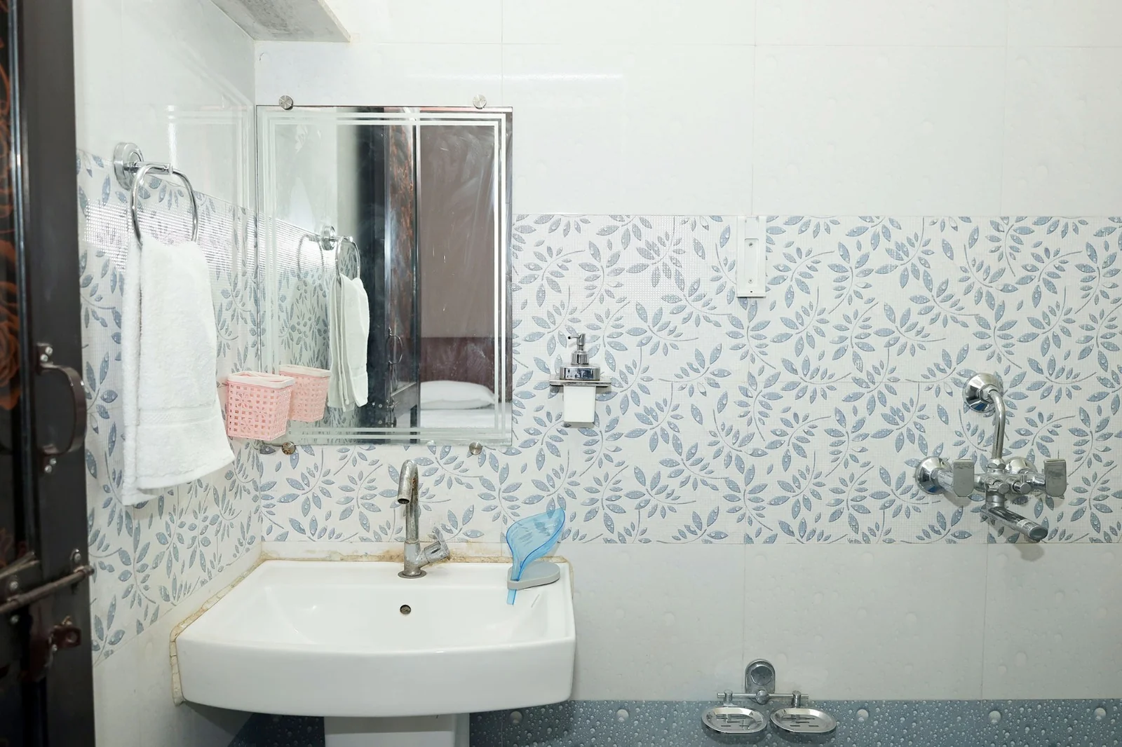 Washroom sink and shower fittings at Meeraavi Home Stay, Udaipur